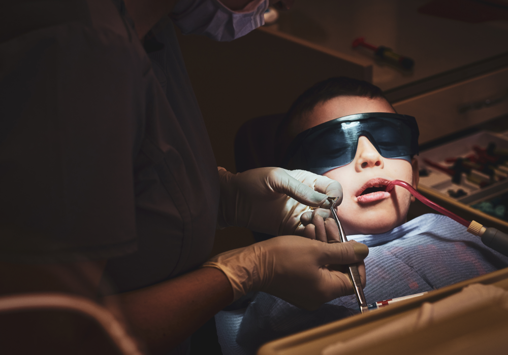 Dentist performing gentle laser treatment on patient